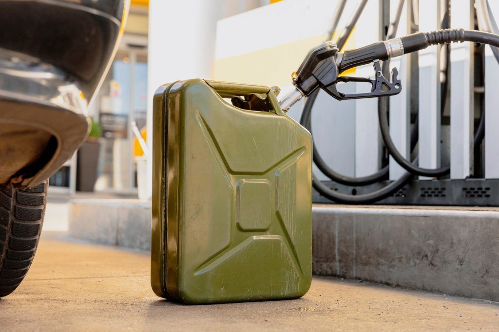 Refilling canister with fuel on the petrol station. Close up view. Fuel, gasoline, diesel